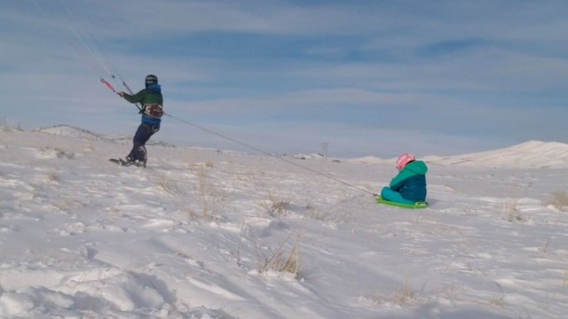 Snowkite sledding