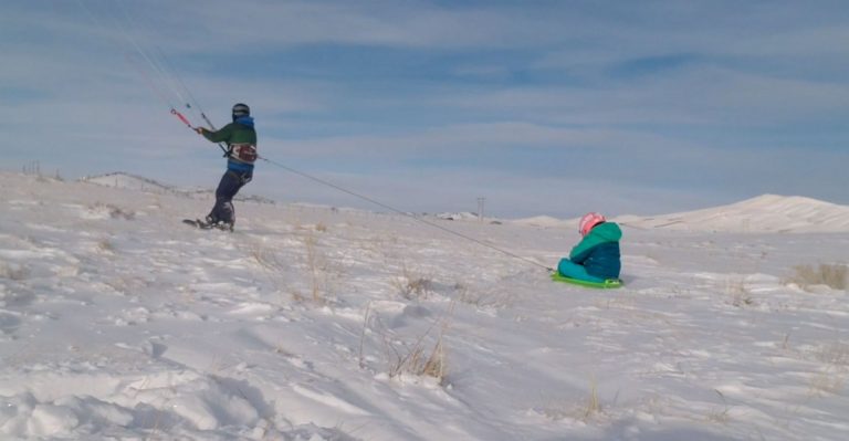 Snowkite sledding