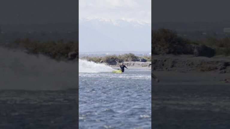 Kiting with snowy mountains in the background
